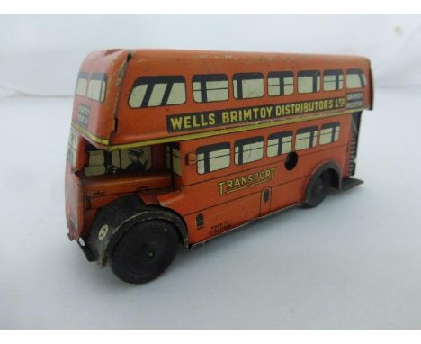 A Brimtoy clockwork tinplate model of a double decker bus in good overall condition.