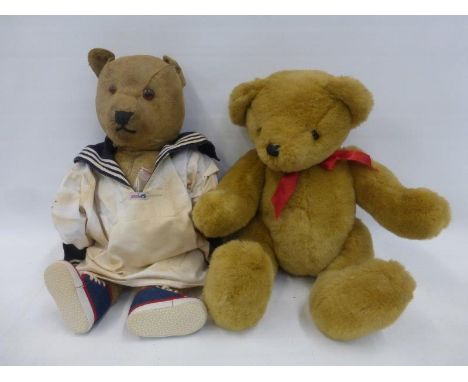 A large teddy bear wearing a sailor's smock, possibly Chiltern, and a Peeko teddy bear.