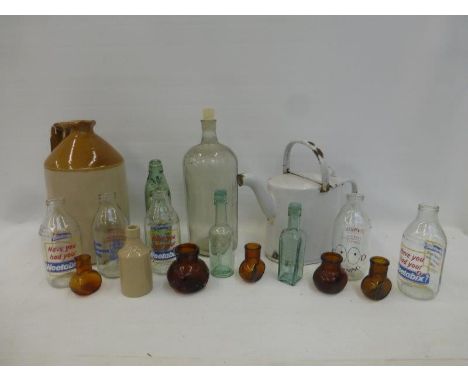 A box of assorted collector's bottles including a large poison bottle, milk bottles advertising Typhoo Tea, Fresh Cotteswold 
