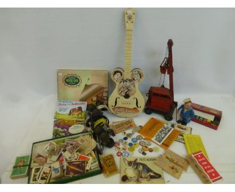A Tri-ang crane, early roller skates, a boxed Sooty xylophone, cigarette collector's cards, a Minic clockwork sailor etc.