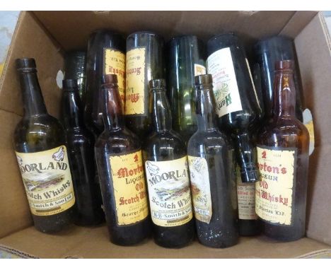A collection of glass Scotch whisky bottles with original vintage labels.