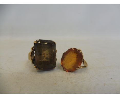 A 9ct gold ring with a amber-coloured stone (possibly topaz), size I and another 9ct gold ring, this one set with a smoky top