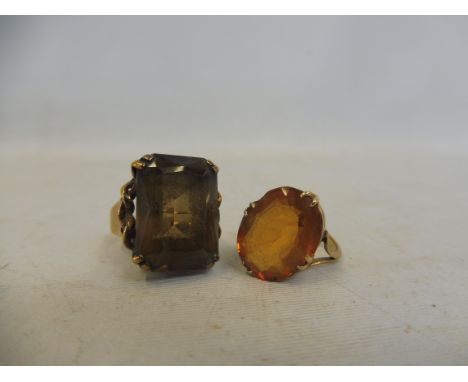 A 9ct gold ring with a amber-coloured stone (possibly topaz), size I and another 9ct gold ring, this one set with a smoky top