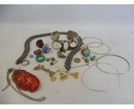 A large carved amber pendant on chain and various pieces of jewellery including a pair of yellow metal earrings marked 585, a