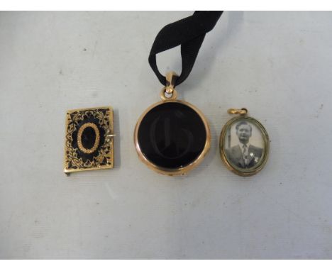 A Victorian yellow metal (probably gold) mourning double sided locket pendant, a yellow metal miniature locket in the form of