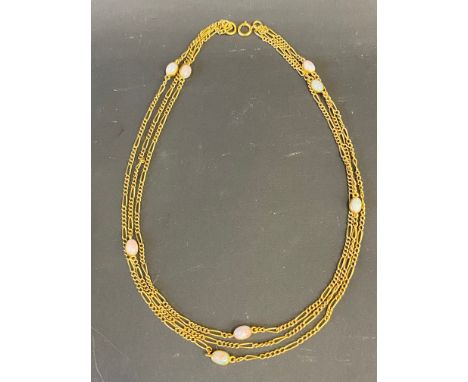 A yellow metal, probably gold, three strand (graduated in length) necklace interspersed with eight opals, the longest length 