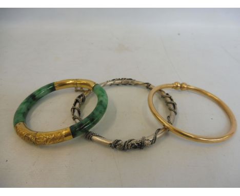 An excellent quality yellow metal and jade bracelet with safety chain, a yellow metal bangle (probably gold) and one other.&n