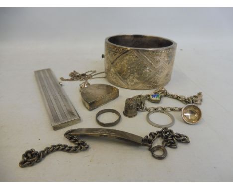 A large silver bangle, Birmingham 1960, a silver mounted comb and various silver jewellery.&nbsp;