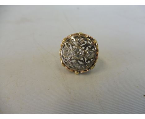 An unusual five stone diamond ring set in gold.