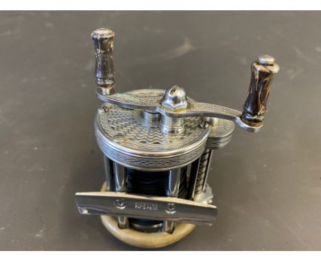 A Phlueger Summit Multiplier level wind anti-backlash fishing reel, engraved both sides.