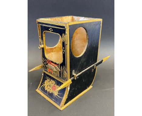 A black lacquer model of a sedan chair, to the back Marcovitch Sedan Cabinet, 6" high (lacks lid).