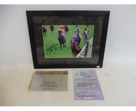 A framed and glazed signed photograph of Willie Carson plus a Porsche 944 52 Driver's Manual.&nbsp;