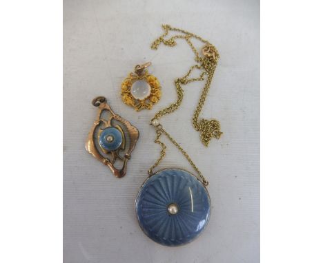 A yellow metal and enamel circular pendant locket with seed pearls; a blue enamel and gold plated pendant and a highly-detail