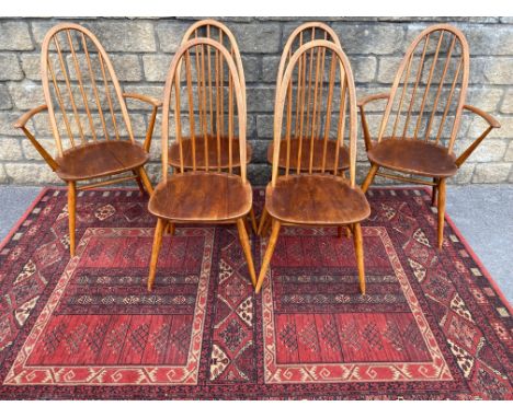 A set of six mid-20th Century Ercol high back dining chairs, two with arms, bearing BS stamp CG 1960 2056.