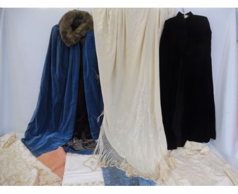 A small collection of vintage costume and textiles, including two capes, a fringed stole and other items.