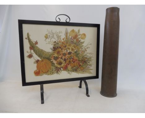 A tall brass WWI shell casing plus a decorative fire screen.&nbsp;