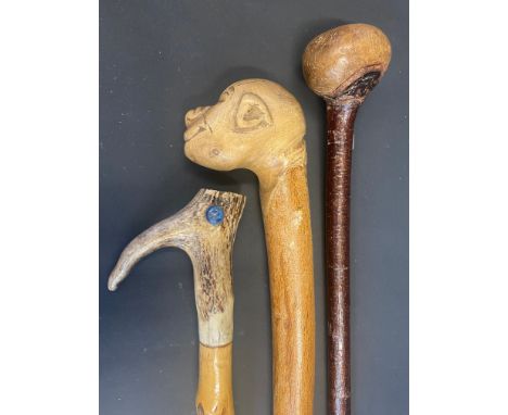 A walking stick with antler handle; and two others (3).