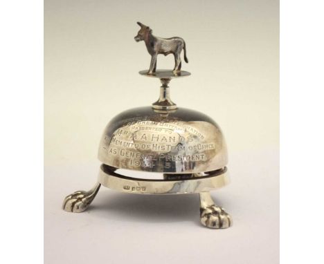 George V silver desk or call bell topped with a figure of a cow and standing on three cast feet, presentational inscription f