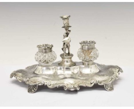 Victorian silver inkstand, the shaped oval stand with engraved decoration, central aperture with figural cover of a knight in