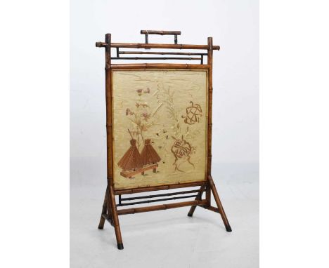 Late 19th Century Aesthetic influence bamboo framed firescreen, the centre glazed with a panel of cream silk embroidered with
