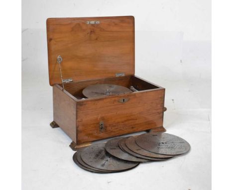 Early 20th Century walnut-cased polyphon, with 3-inch comb, playing 8-inch metal discs, 41cm x 28cm x 20cm high, and fifteen 