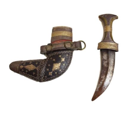 Omani Jambiya, 20th Century, the curved double-edged blade having waisted horn hilt with white metal mounts, L-shaped scabbar