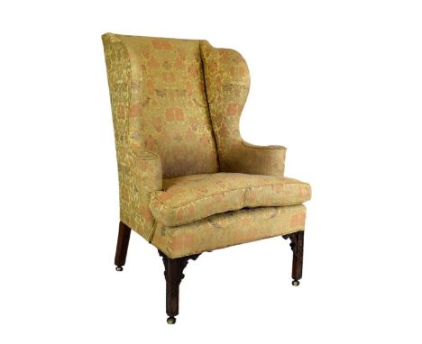 George III wing back armchair on Chippendale-style blind fretwork-carved chamfered front supports, and period brass swivel ca