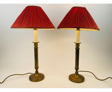 LAURA ASHLEY CANDLESTICK LAMPS, a pair, vintage brass with red pleated shades, 55cm H. (2) (with faults) 