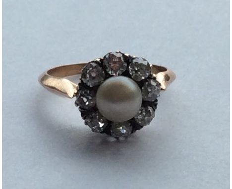A large circular natural pearl and diamond cluster ring in rose gold. Approx. 4 grams. Est. £600 - £800.