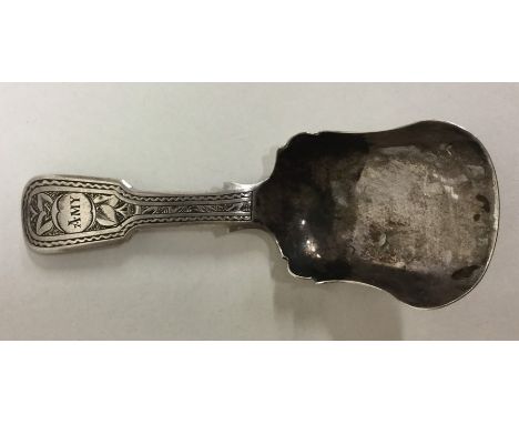 A Georgian bright cut caddy shovel with wavy edge. Approx. 11 grams. Est. £30 - £50.