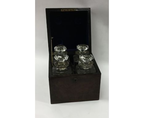 A boxed burr walnut four bottle decanter set with fitted interior and hinged top. Est. £80 - £100.