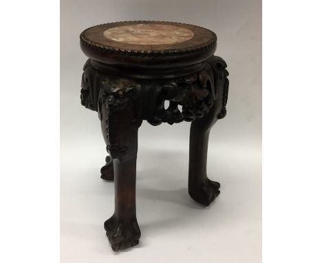 A marble topped circular hardwood planter. Approx. 33 cms high. Est. £150 - £200.