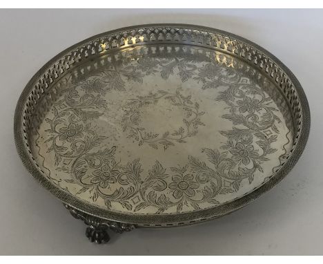 A small circular silver Portuguese waiter decorated with flowers and leaves on bracket feet. Approx. 22 cms in diameter. Appr