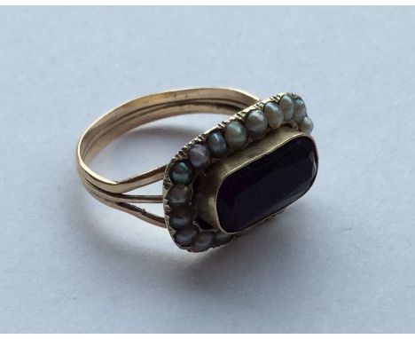 An Antique amethyst and pearl cluster ring in 9 carat mount. Approx. 3.3 grams. Est. £30 - £50.