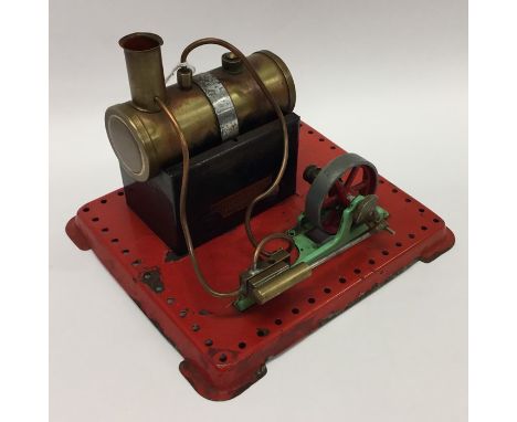 A Mamod steam engine on red base with burner. Est. £40 - £50.