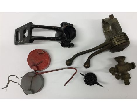 A "Castrol Engine Timer" sticker on card together with two fuel can lids; a Lucas lamp bracket and other vehicle accessories.