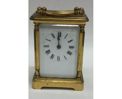 A small brass carriage clock on bracket feet. Est. £30 - £40.