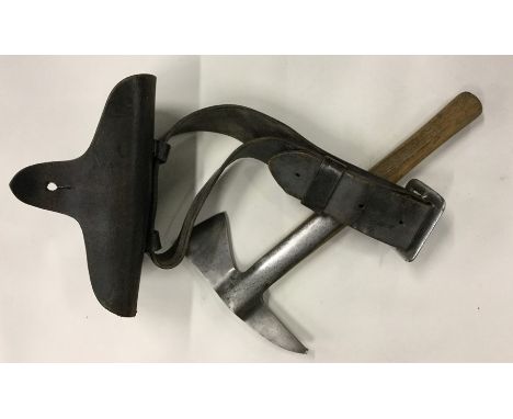 An unusual Merryweather fireman's axe with oak handle contained within a leather sheath and belt. Est. £40 - £60.