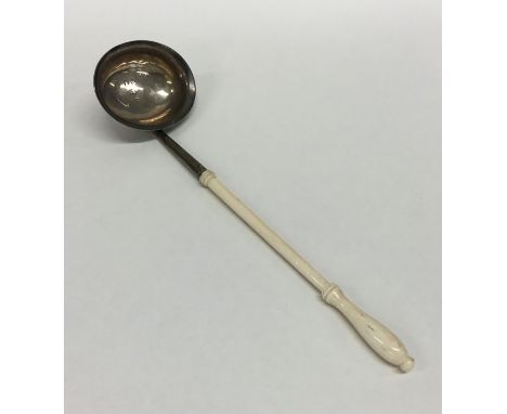 A Georgian miniature toddy ladle with turned ivory handle. London. By EM. Approx. 18 grams. Est. £30 - £40.