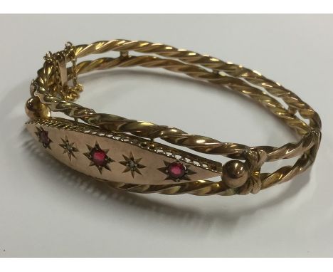 A 9 carat fancy diamond twist bangle with concealed clasp. Approx. 9 grams. Est. £120 - £150.
