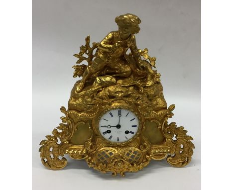 A good French gilt mantle clock with finial top. Est. £60 - £80.
