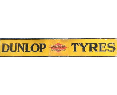 A large rectangular "Dunlop Tyres"  metal sign mounted on board. Approx. 185 cms x 29 cms.