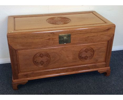 A camphor wood hinged top trunk with brass handle. Est. £40 - £60.