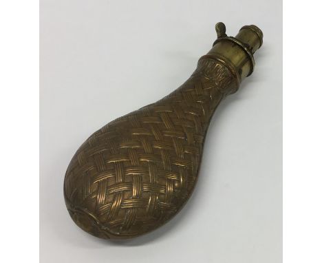 An Antique copper and brass shot flask with weave decoration. Est. £20 - £30.