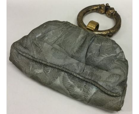 An unusual Continental silver gilt bangle mounted as a bag. Est. £20 - £30.