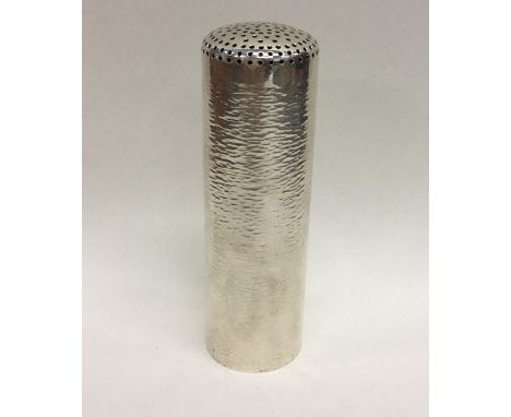 STUART DEVLIN: A rare cylindrical silver sugar caster with textured body. London. Approx. 15 cms high. Approx. 201 grams. Est