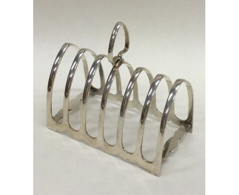 A large heavy silver seven bar toast rack on bracket feet. Sheffield. Approx. 145 grams. Est. £60 - £80.