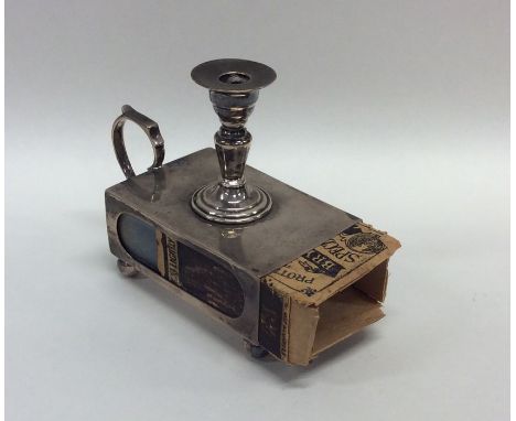 An unusual novelty silver match holder in the form of a chamber stick on ball feet. Approx. 68 grams. Est. £40 - £60.