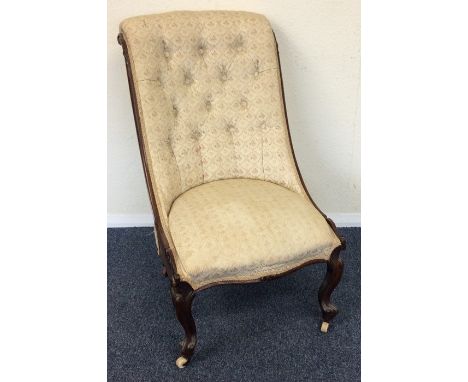 A mahogany button back nursing chair with scroll feet. Est. £30 - £50.