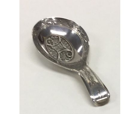 A good quality Georgian bright cut silver caddy spoon attractively decorated with wriggle work. Birmingham. By Samuel Pembert